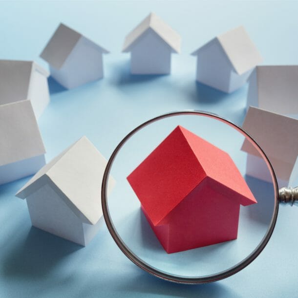 red house under magnifying glass