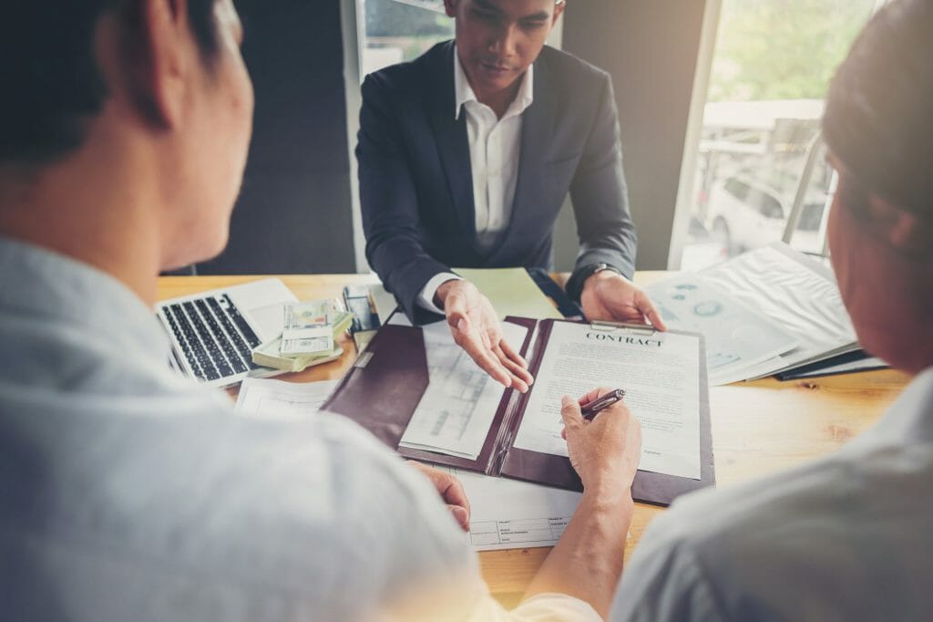 People in a meeting signing a contract