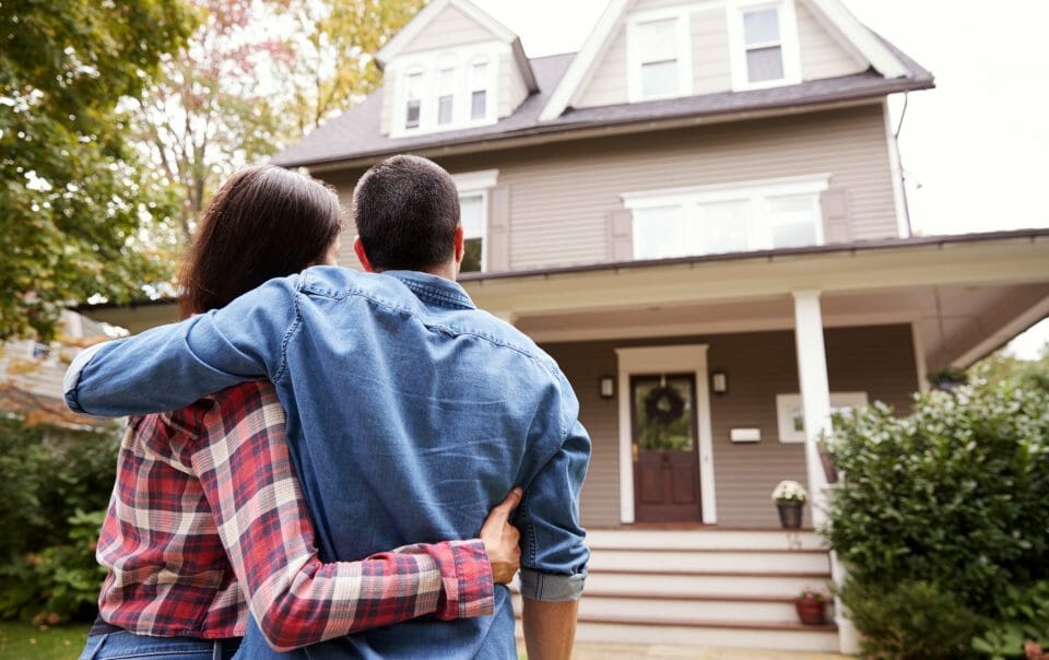 couple in front of new home