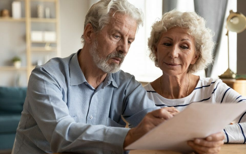 older couple looking at paper