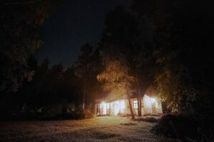 Brightly Lit House in Dark Woods