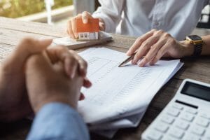 Woman Going Over Paperwork With Client