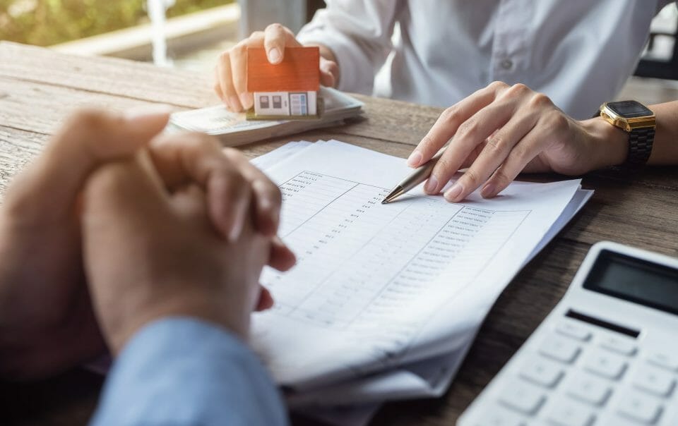 Woman Going Over Paperwork With Client