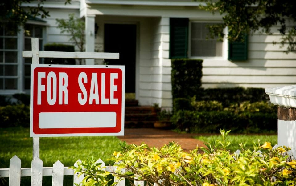 House with For Sale Sign in Front Yard